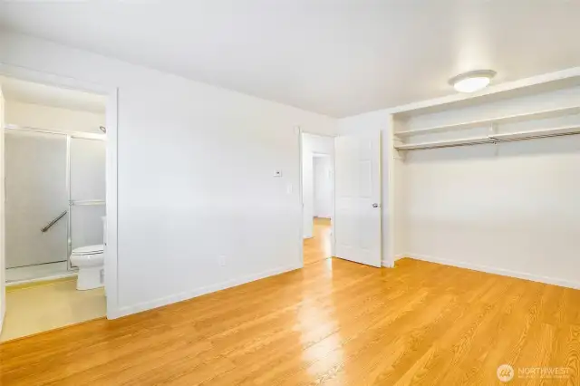 Primary bedroom and bathroom. You'll love the beautiful vinyl/hardwood look of the floors and open closet.
