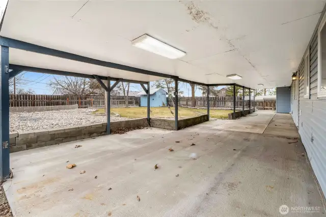 What a GREAT covered patio! I imagine grilling out here, fun with little toys, a party of friends, a swimming pool  or trampoline on the rocky area. There are many possibilities!