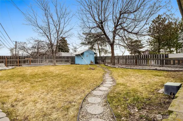 What a lovely pathway to the garden shed and lots of grass for little ones' imagination. Plus, the backyard is fully fenced.  That's a bonus!