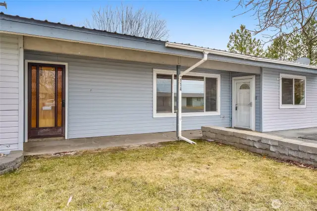 Two front doors to access the home. Enter into the white door to go into the family room.
