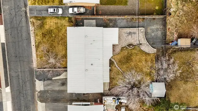 As you can see, the backyard has a wonderful shade tree, more parking, and a rock garden. The shed is handy for garden tools.