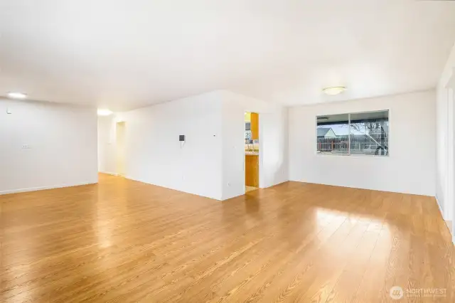 A view of the living room and dining room. That first doorway is one of the kitchen entry doors.