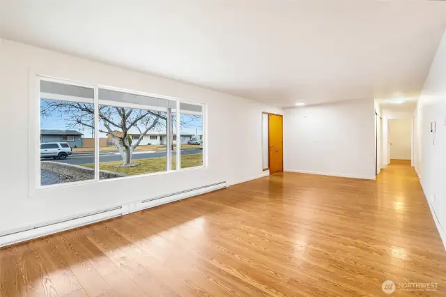 The large living room has a lot of natural light! The hallway leads to three of the bedrooms.