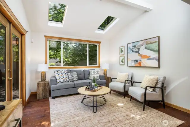 Family room in the back of the house (also could be a 5th bedroom- has a closet). Skylights and French doors bring in all the natural light.