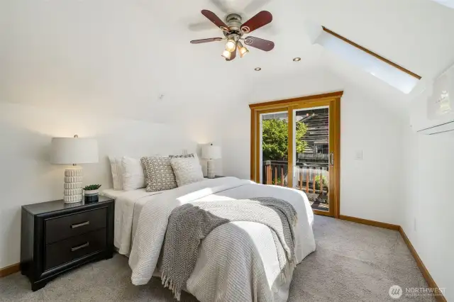 Upstairs primary with newer sliding door, replacing the French doors, takes you out to a small balcony.