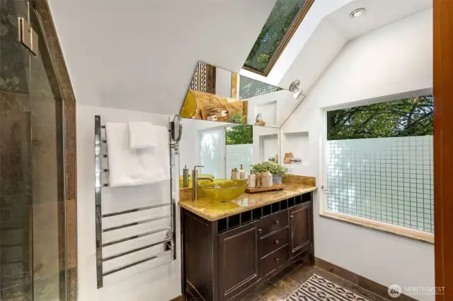 Large vanity, skylights and large windows, privacy film on window.