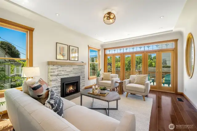 This house is filled with LIGHT! 3 sets of French doors open out to the large front deck- looking West. Newer gas fireplace insert.