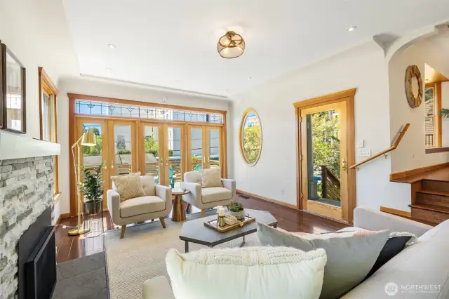Glass front door lets in even more light and the front entrance wraps around to the deck and with stairs to the back yard as well.