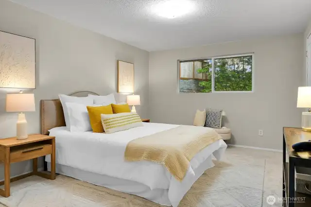 Spacious primary bedroom overlooking the serene backyard.