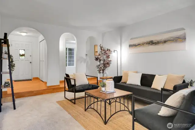 Elegant arches provide a graceful entry into the expansive living room.