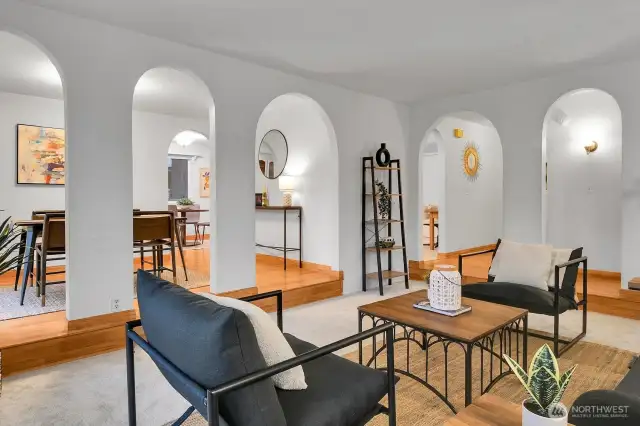 The elegant archways continue seamlessly into the dining room, creating a cohesive architectural flow.