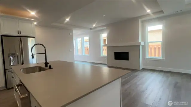 This quartz island is massive and great for entertaining. LVP throughout, FP w/mantel.