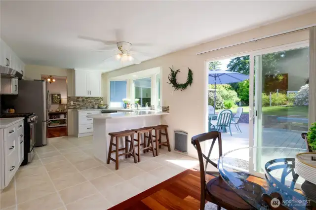 Step out effortlessly from the kitchen and dining area through the sliding glass doors onto the spacious back deck and patio. This seamless indoor-outdoor flow creates the perfect setting for alfresco dining, relaxing with friends, or enjoying quiet mornings surrounded by your beautifully landscaped yard.