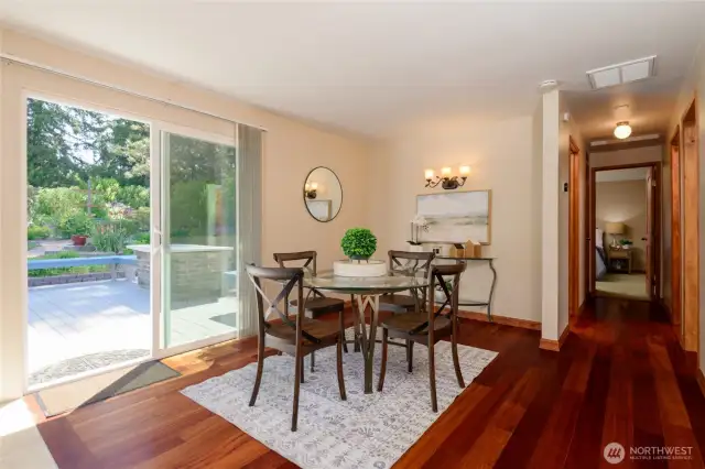 The dining room features a convenient sliding door that opens directly onto the back deck and yard, blending indoor comfort with outdoor living. Gorgeous hardwoods flow beautifully throughout the main living areas.