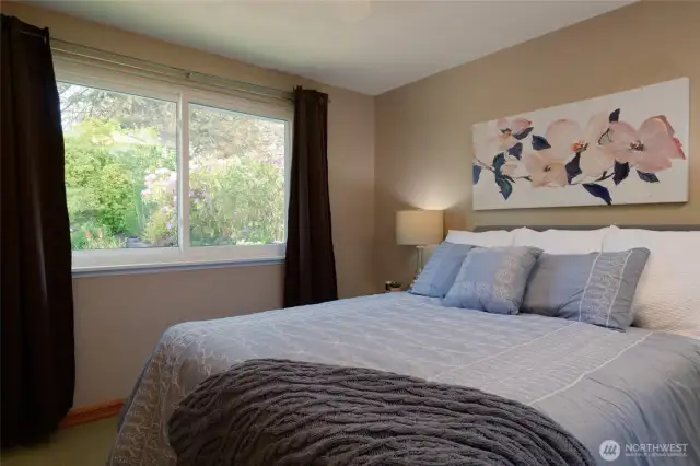 Wake up to tranquil views of the beautifully landscaped backyard from the comfort of your primary suite.