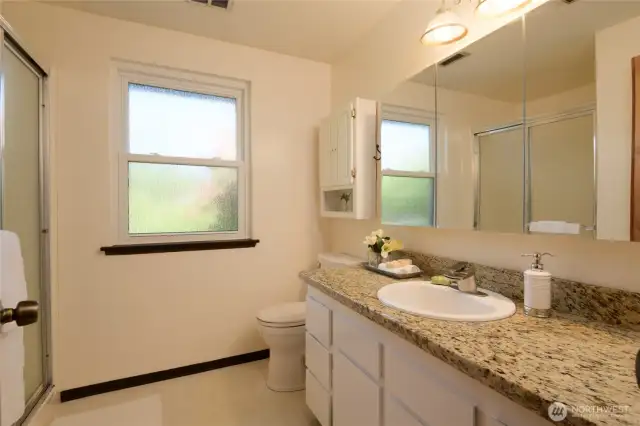 Adjoined to the primary bedroom is a private en suite ¾ bath, offering a quiet retreat all your own. Featuring durable granite countertops, a walk-in shower - perfect for starting and ending your day in peace.