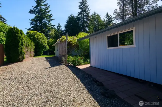 Plenty of room for your RV and/or boat—no need to pay for off-site storage! Tucked discreetly beside the beautifully landscaped yard, the dedicated RV parking area offers both convenience and privacy. Shielded by mature plantings and thoughtful design, your RV or trailer is easily accessible without detracting from the home's curb appeal.