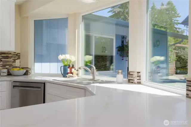 The brand-new kitchen is thoughtfully designed to be both beautiful and functional, featuring an open layout with an abundance of counter and storage space.