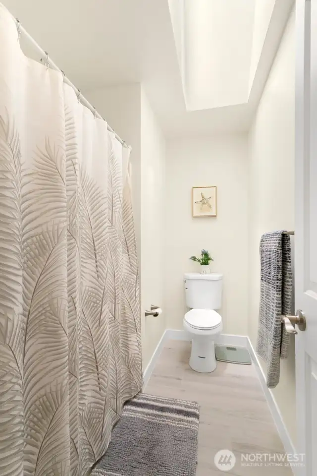 Shared upstairs bathroom with skylight