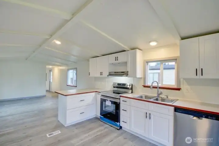 View of kitchen with sitting bar and living room.