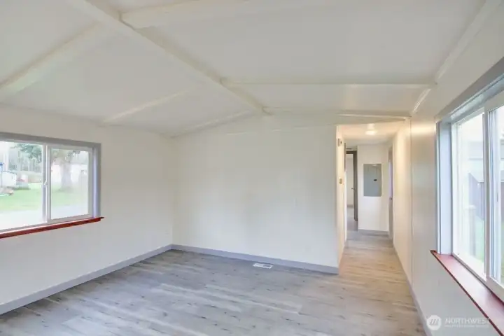 Living room and view of the hallway to the bedrooms and bathroom. There is another door to the west yard with a shed.