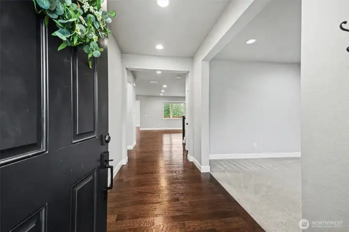 The spacious entrance welcomes you into the home, showcasing beautiful flooring, recessed lighting and neutral color palette throughout.