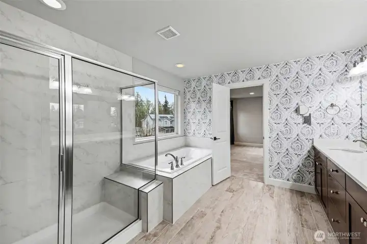 Primary en-suite with a separate water closet, dual sinks, soaking tub, and large walk-in shower.