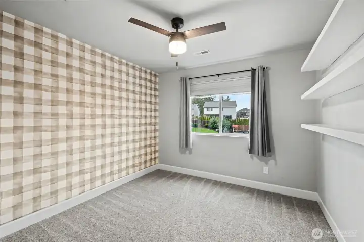 Upstairs guest bedroom with ceiling fan.
