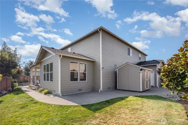 Side yard with patio space and grass area.