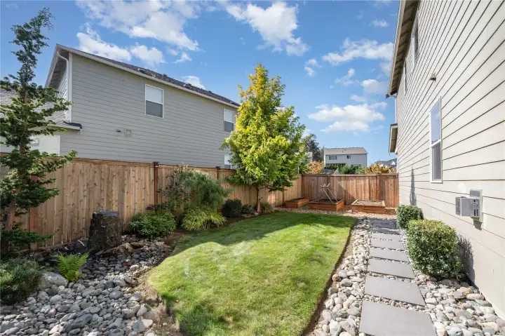 A peaceful rock fountain enhances the serene setting, while multiple outdoor nooks create endless possibilities for entertaining or unwinding.