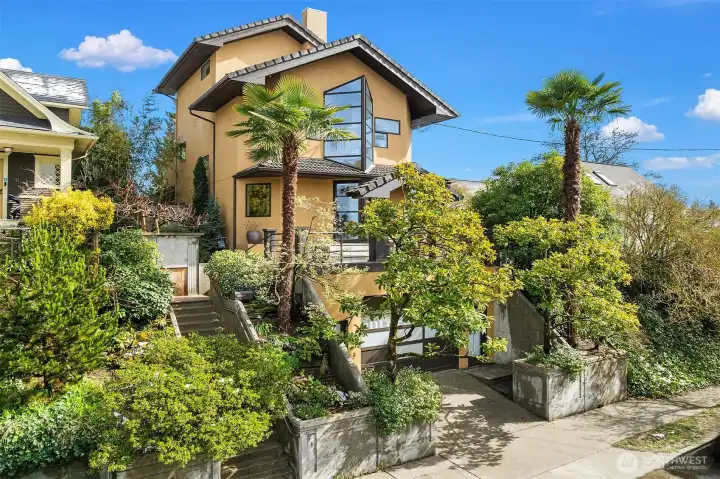 Elevated entry framed by mature landscaping