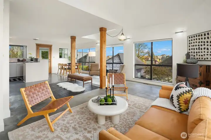 Great room with exposed timber rises from polished concrete floor