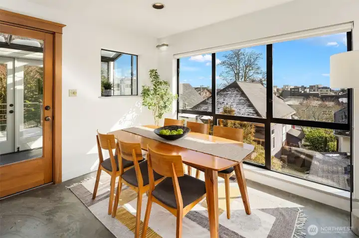 Dining area with expansive windows and direct connection to outdoor living