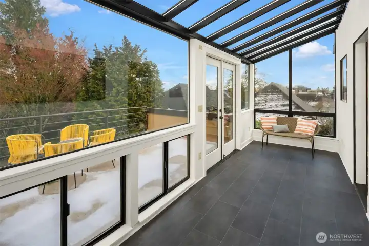 Sun-filled glass-enclosed sunroom extending the living space year-round