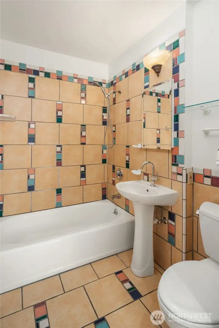 Well-appointed apartment bath with clean finishes and functional design