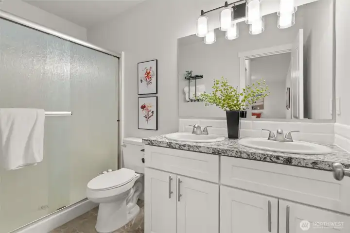 Primary bathroom with double sinks and shower