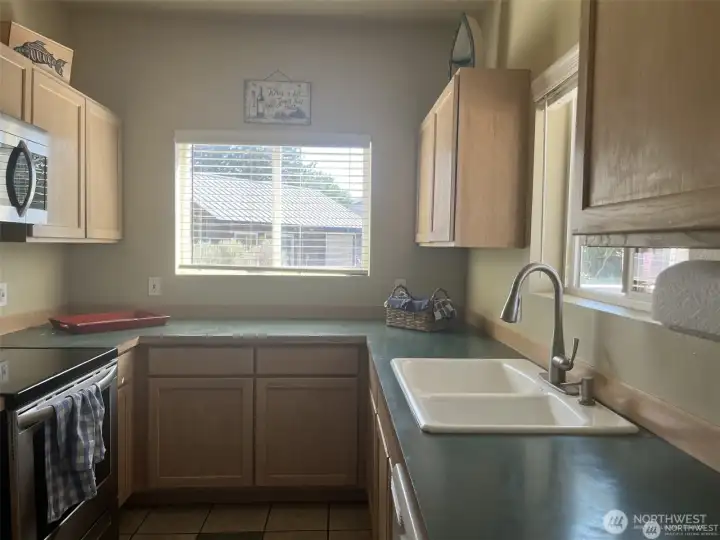 Galley kitchen with room for expansion. You can use the kitchen window to serve food outside to the deck.