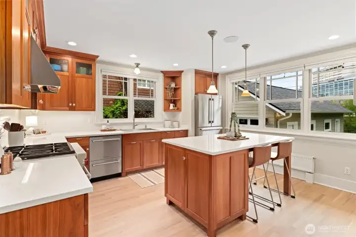 True chef’s kitchen with elegant marble countertops & high-end Bosch, Fisher & Paykel, and Wolf appliances
