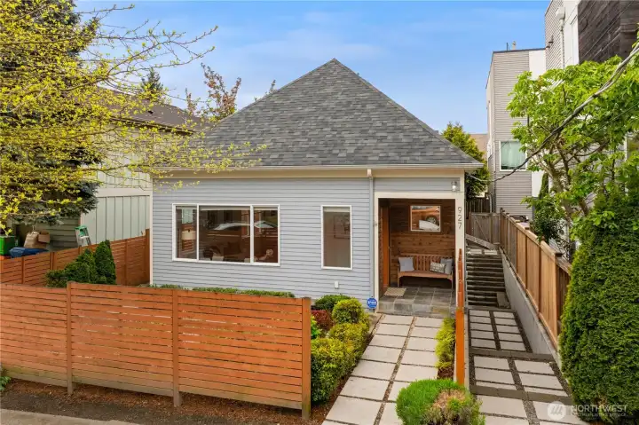 Beautiful curb appeal with mature landscaping and a beautiful covered front porch