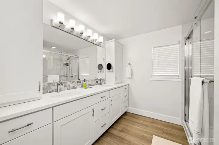 Primary bathroom has double sinks and a beautiful walk-in shower