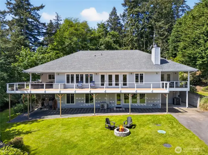 Impressive custom home with an expansive view deck, beautifully manicured grounds, and a resort-style backyard complete with a fire pit for unforgettable outdoor living.