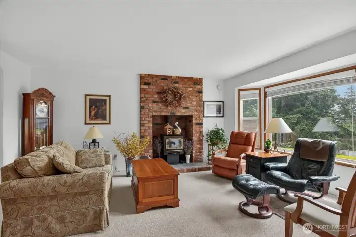 Beautiful living space with natural gas woodstove insert. Large picture windows which allow a lot of natural light.