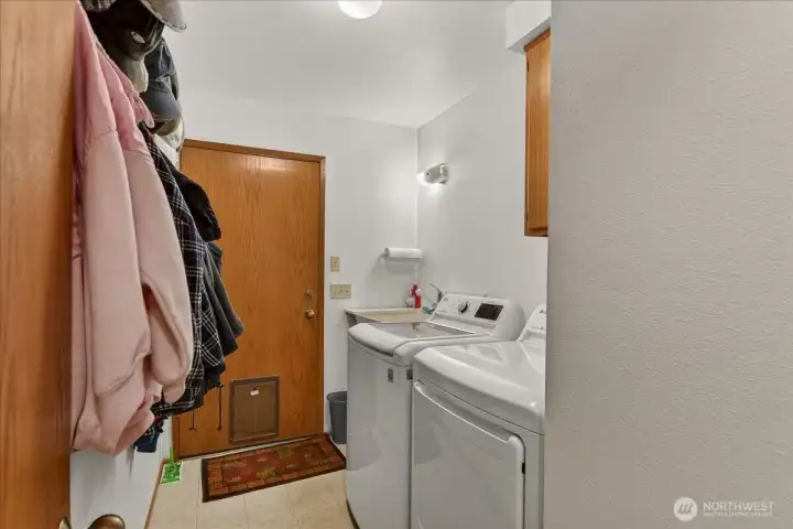 Mud room with utility sink and access to the garage.