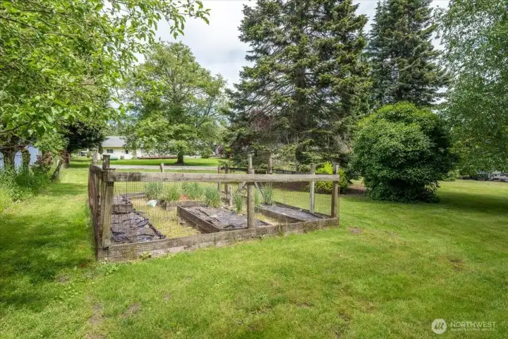 Dedicated garden space with raised beds and water.