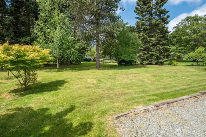 Side yard with this gravel section is set up for RV parking with plug in.