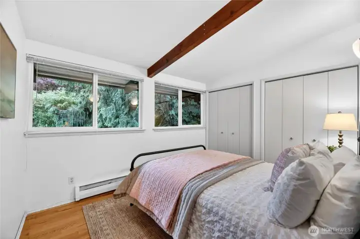 Down the hall to the second bedroom. The beams continue throughout the main level of the home.