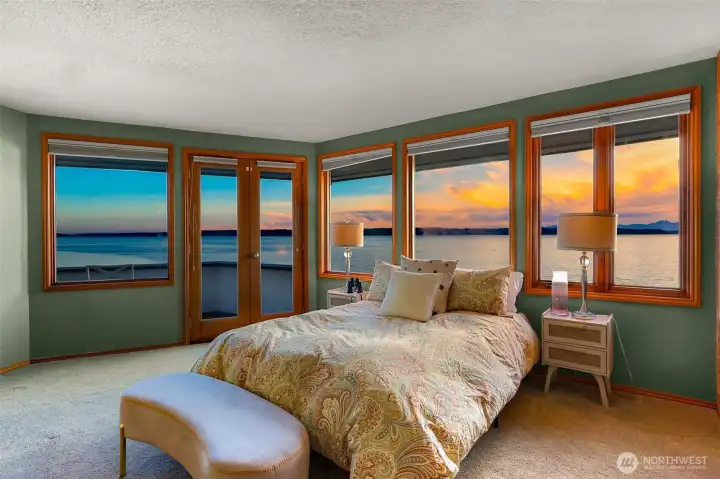 Peaceful upstairs primary bedroom offering a private balcony and ensuite bath for ultimate convenience and comfort.