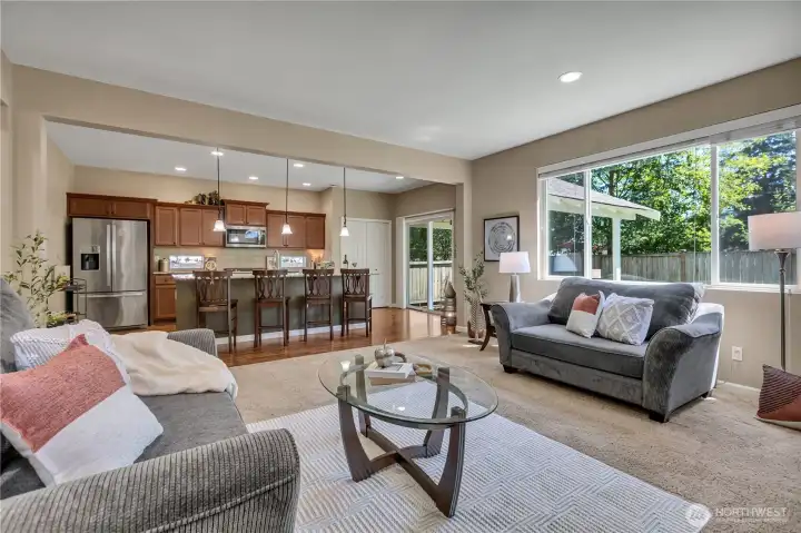 Bright, Open Kitchen with Slab Granite Countertops, Large Island and plenty of Seating.