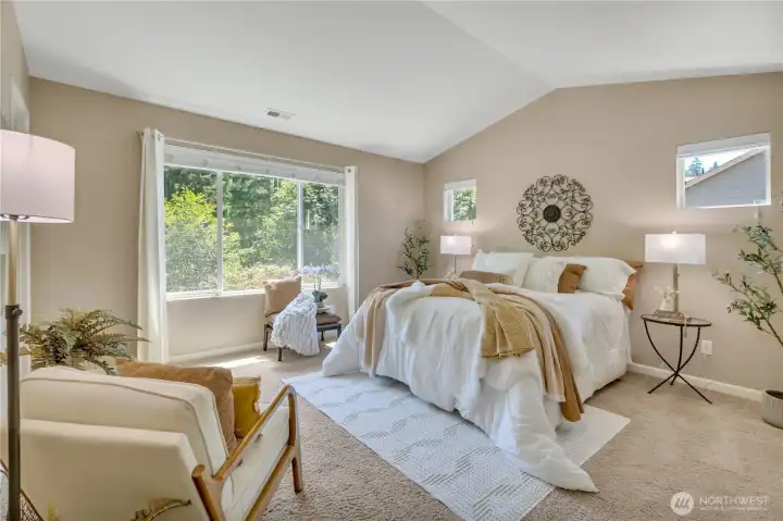 Large Primary Bedroom with Vaulted Ceiling Overlooking the Private Greenbelt.
