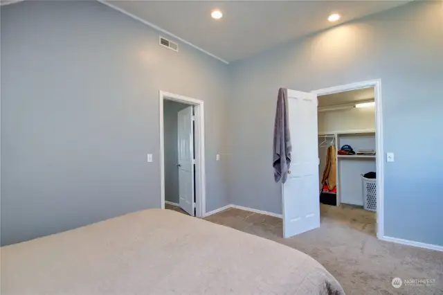 A spacious closet just off the primary bedroom, offering lots of storage with built-in shelves.